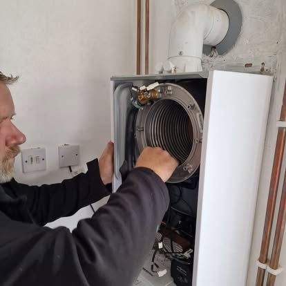 Sparta gas engineer working on the internals of a domestic gas boiler